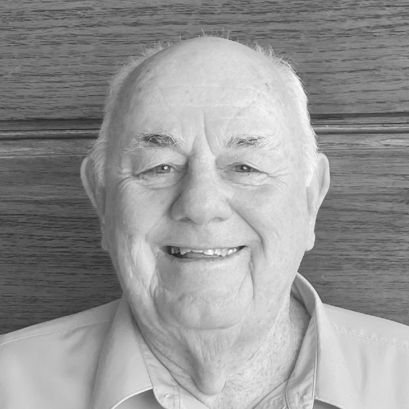 Image of man in front of a wooden wall