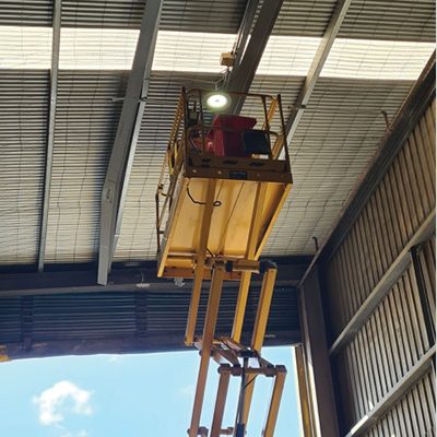 CSG techs working on the elevated platform inside a grain intake area